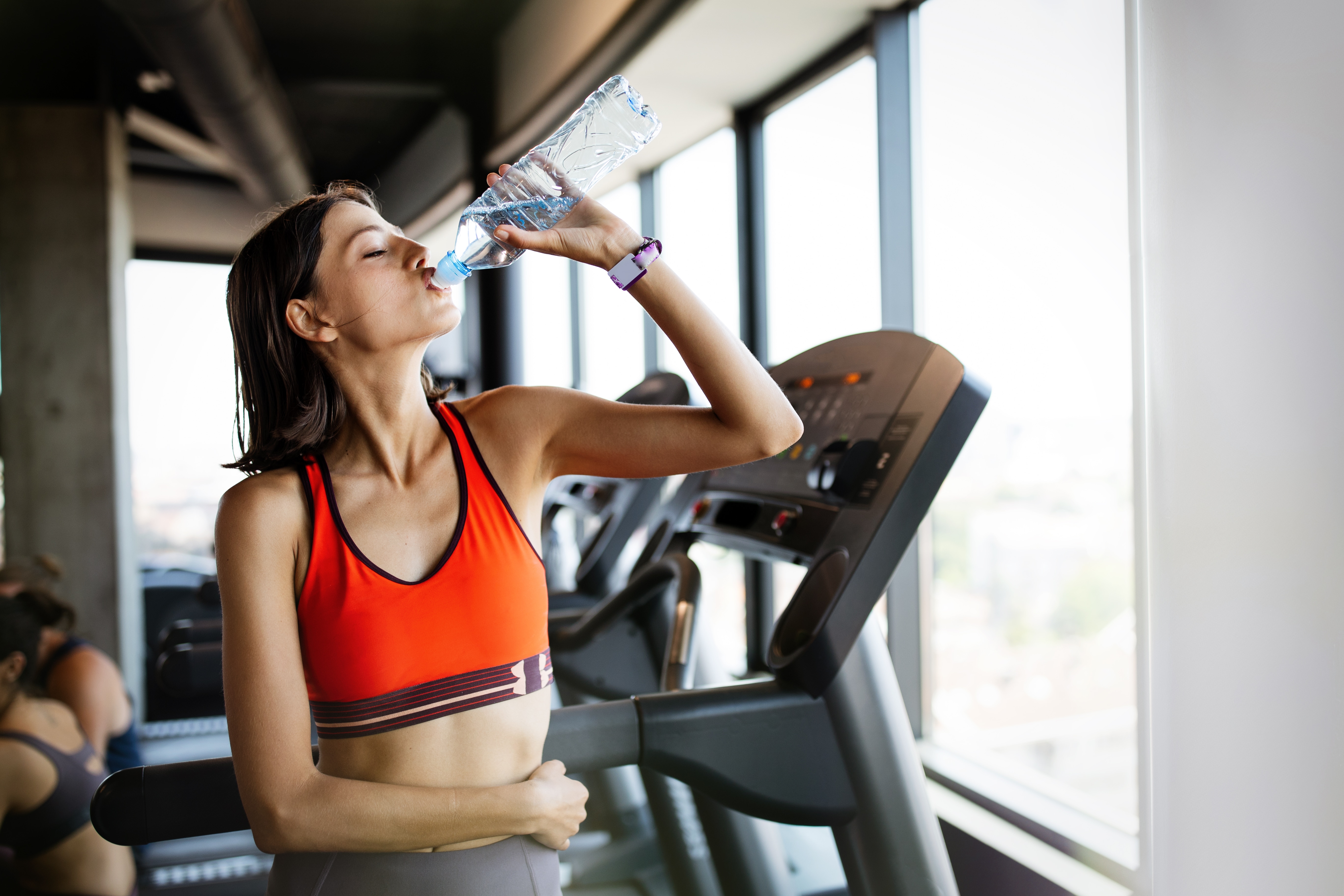 lady drinking water after workout